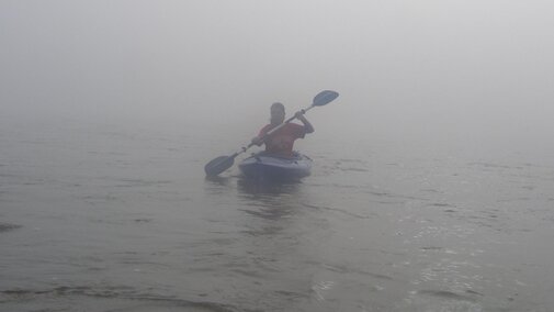 Lauren Dinan kayaking down the river in the mist