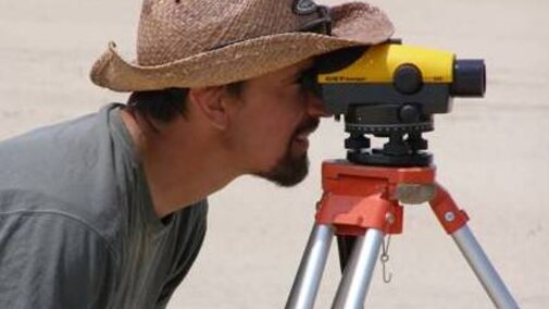 Joel Jorgensen surveying the topography of a sandbar